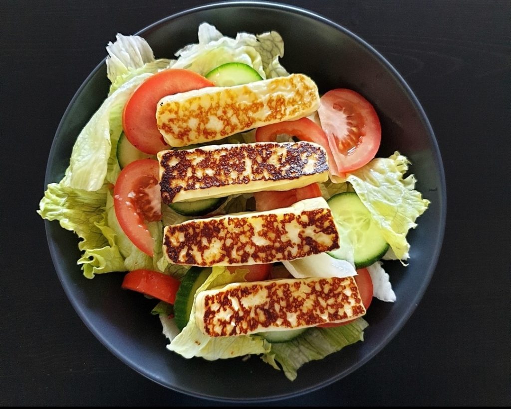 Strips of grilled L Artisan Organic Haloumi on salad
