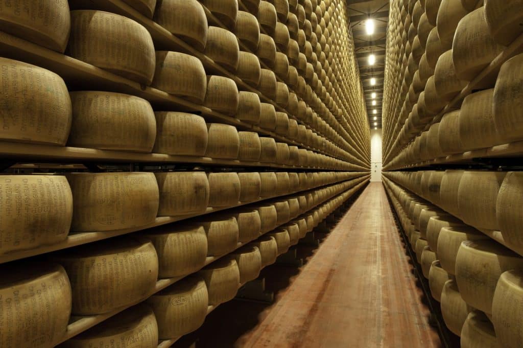 Stacks of wheels of Parmigiano Reggiano in maturation rooms