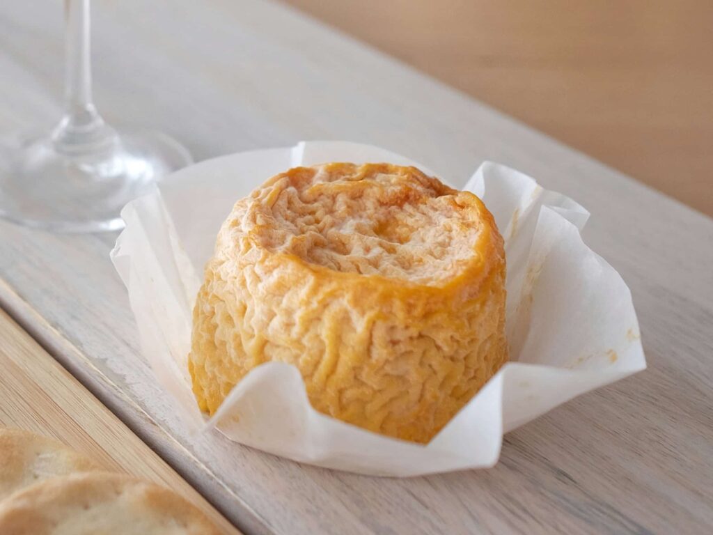 Tiny round of Langres with champagne flute