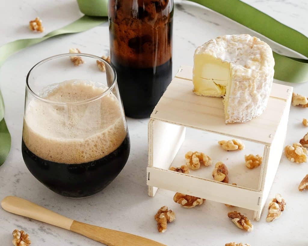 Small round of Brewers Gold cheese with dark beer