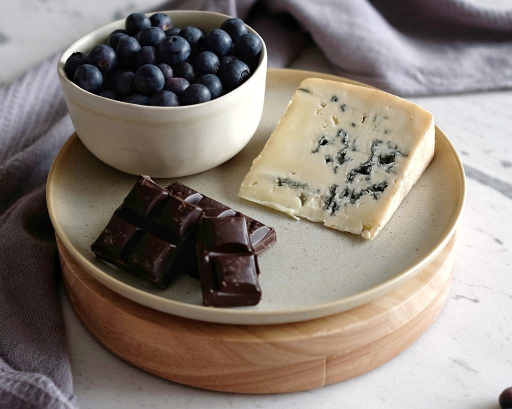 Venus Blue with a bowl of blueberries and dark chocolate