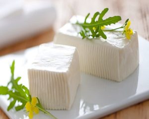 Fresh white Italian cheese Crescenza on a plate