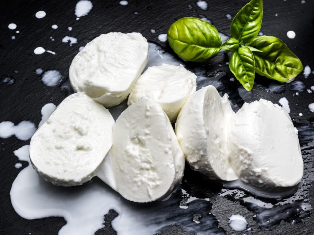 Ball of Fior di Latte sliced on slate board