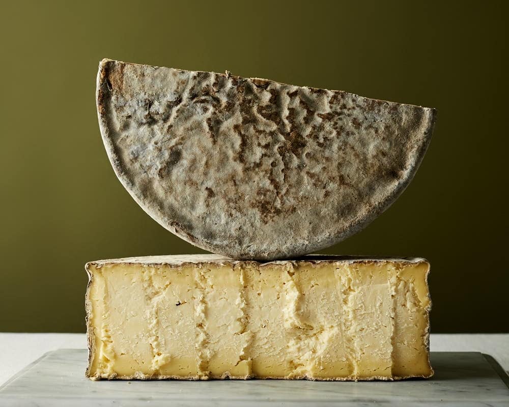 Wheel of Gorwydd Caerphilly cut in half showing the crumbly texture