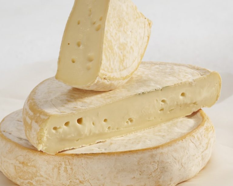 Soft oozy cheese Reblochon de Savoie cut and stacked