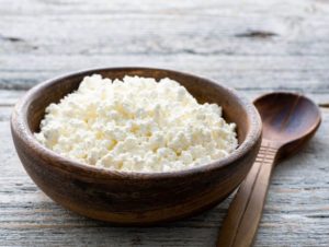 Fluffy Anevato white cheese in a wooden bowl