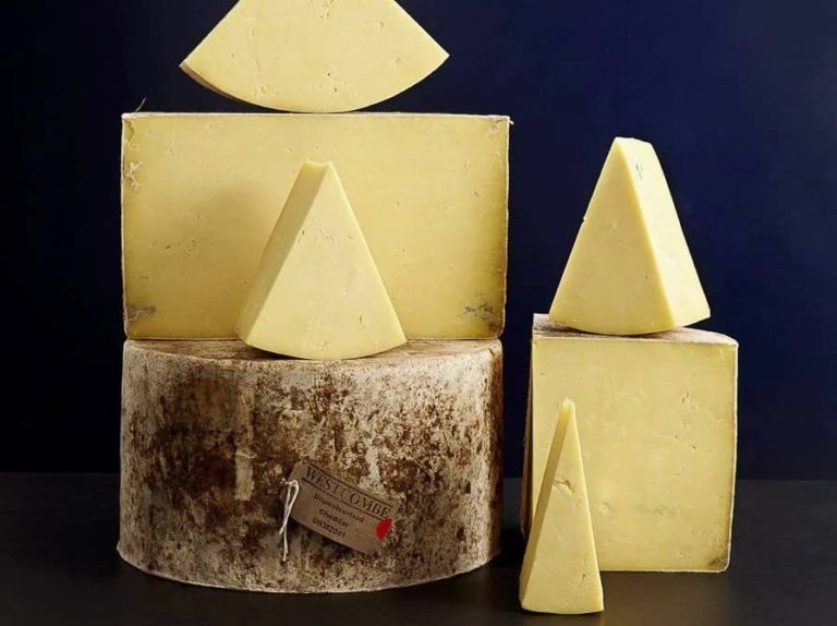 Cut wheels of Westcombe Cheddar hard cheese