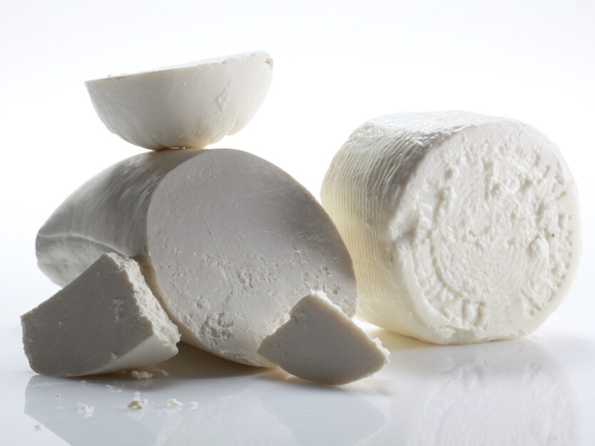 Fresh white Manouri cheese on a white plate