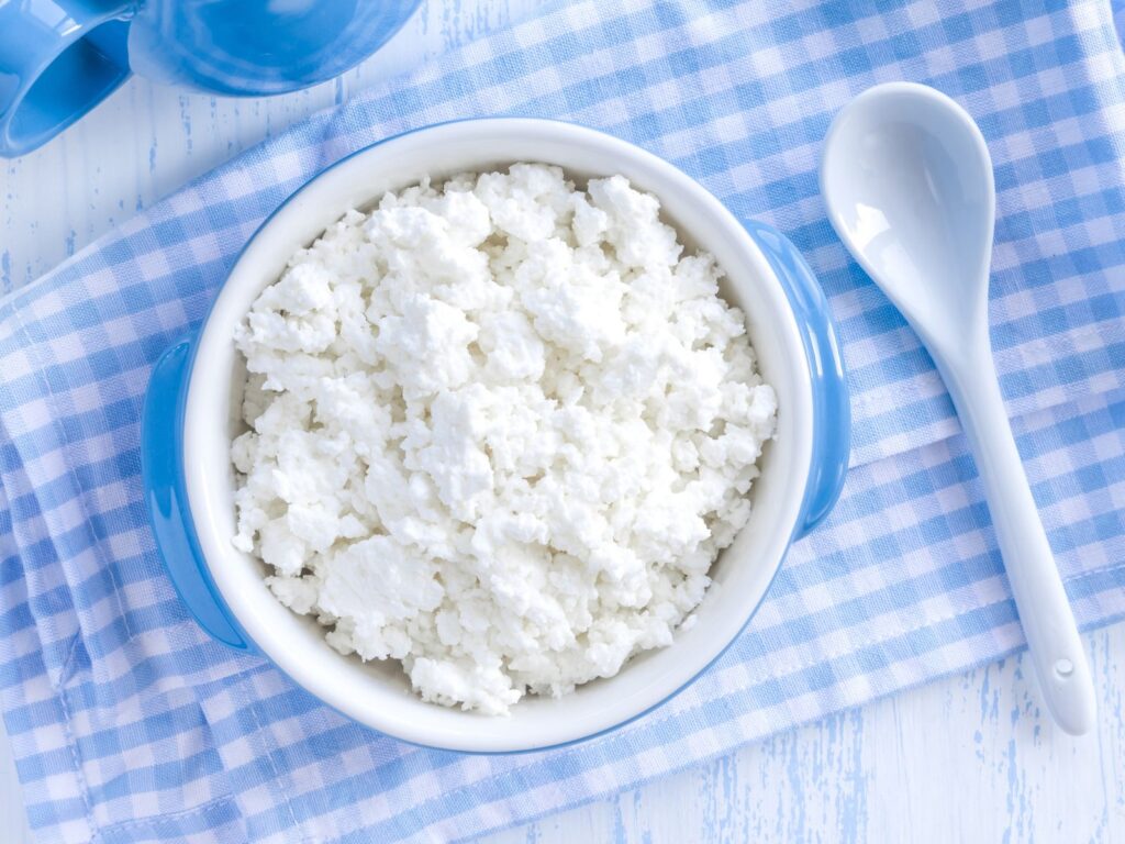 White fluffy Xynomizithra Kritis cheese in a white bowl