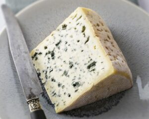 Wedge of Bleu d'Auvergne blue cheese on a grey plate