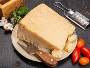 Wedge of hard Grana Padano cheese on a plate
