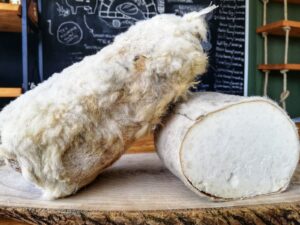 Hard crumbly Tulum Peyniri cheese inside goat skin bag