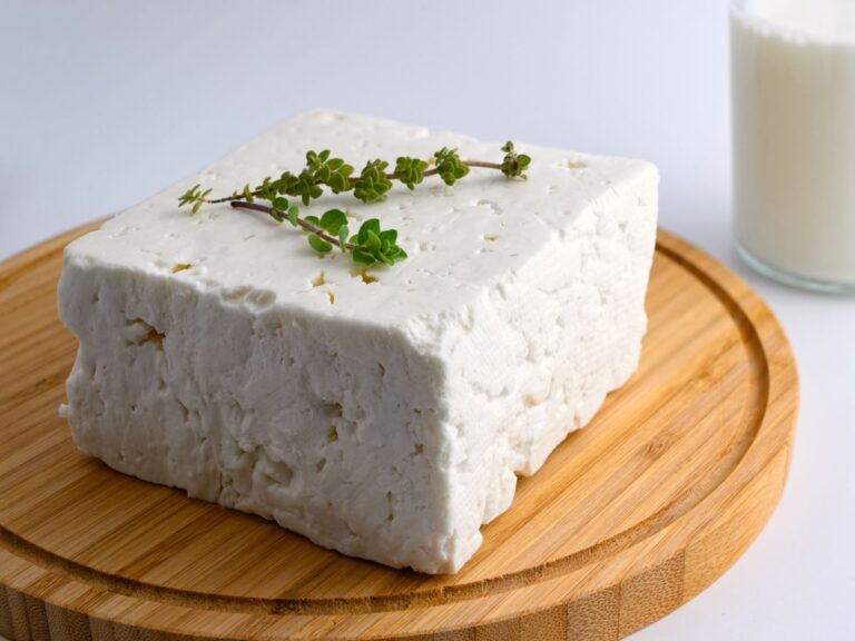 Block of Sirene white cheese on a circular wooden board